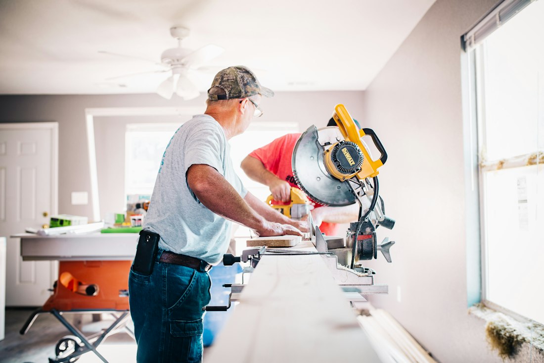 Carpenter cutting trim on a miter saw
